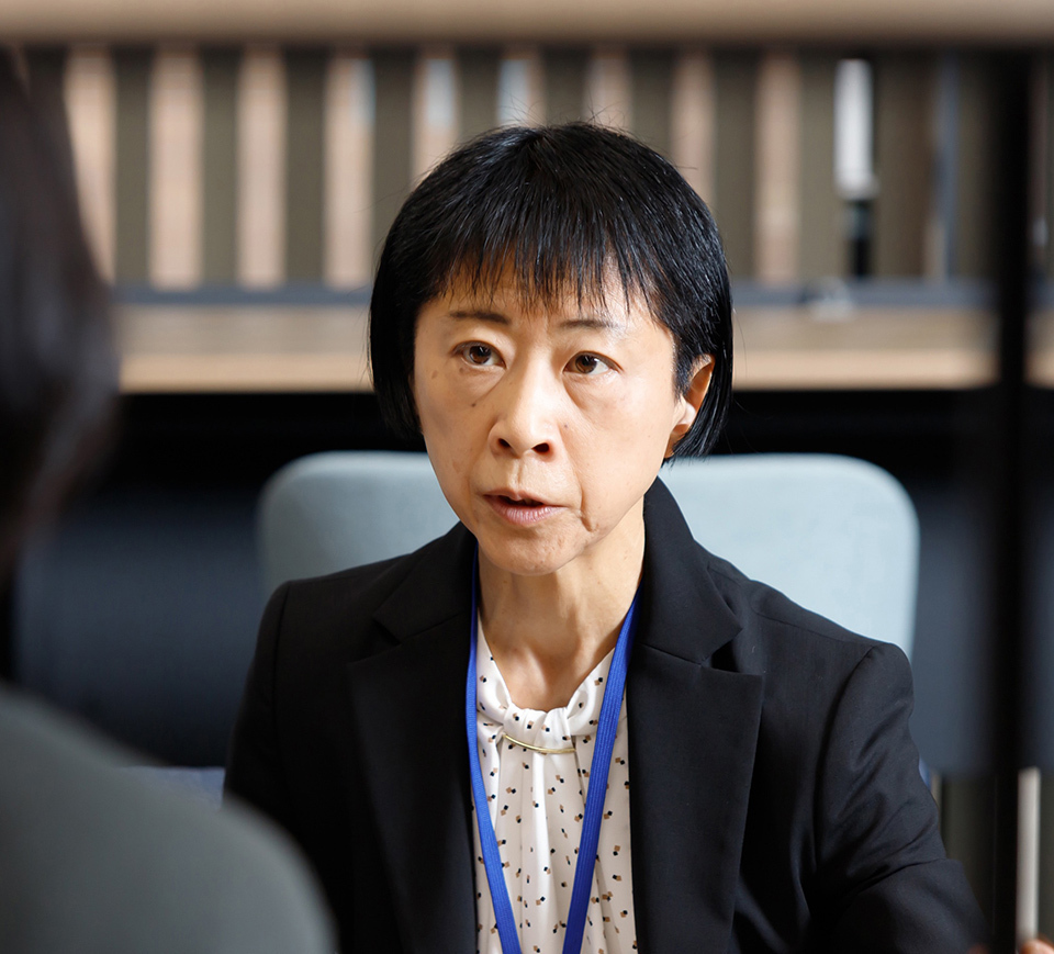 A woman speaking with a serious look on her face.