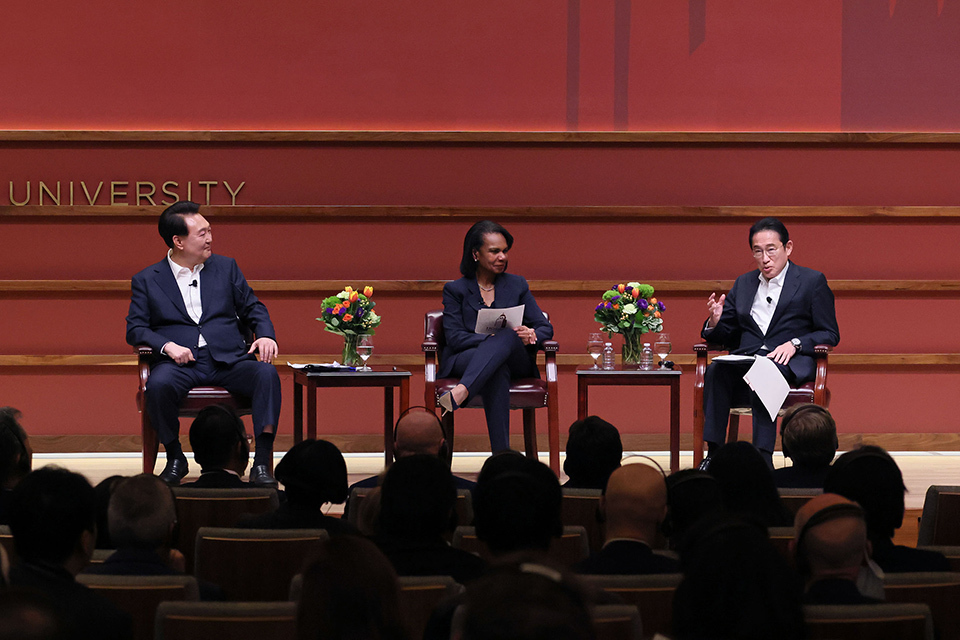 Prime Minister Kishida of Japan (right), Condoleezza Rice (center), and President Yoon of the Republic of Korea (left) are seated on stage.