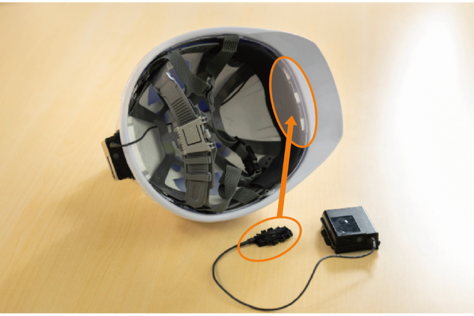 The orange frame inside the brim of the helmet indicates where the sensor is to be attached.