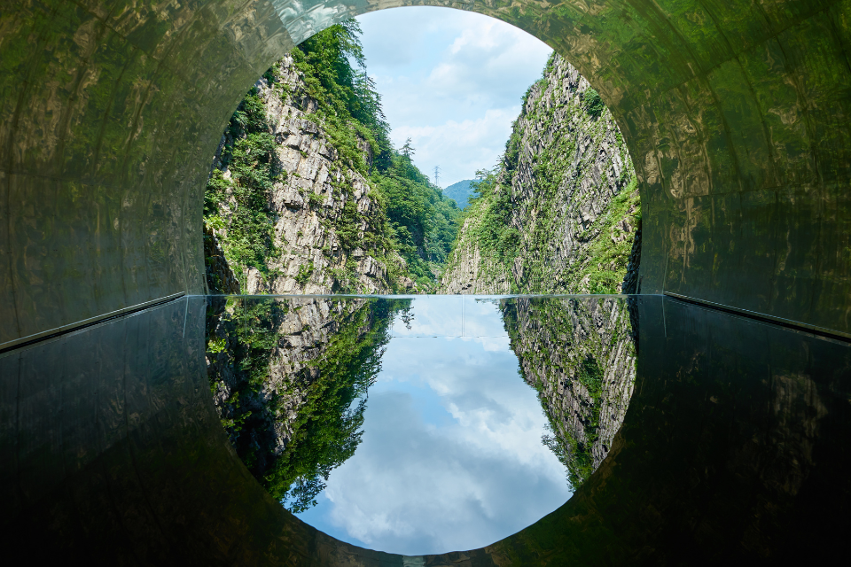 The Kiyotsu Gorge Tunnel, lined with stainless steel plates and flooded with water so that the view of the valley is reflected inside the tunnel