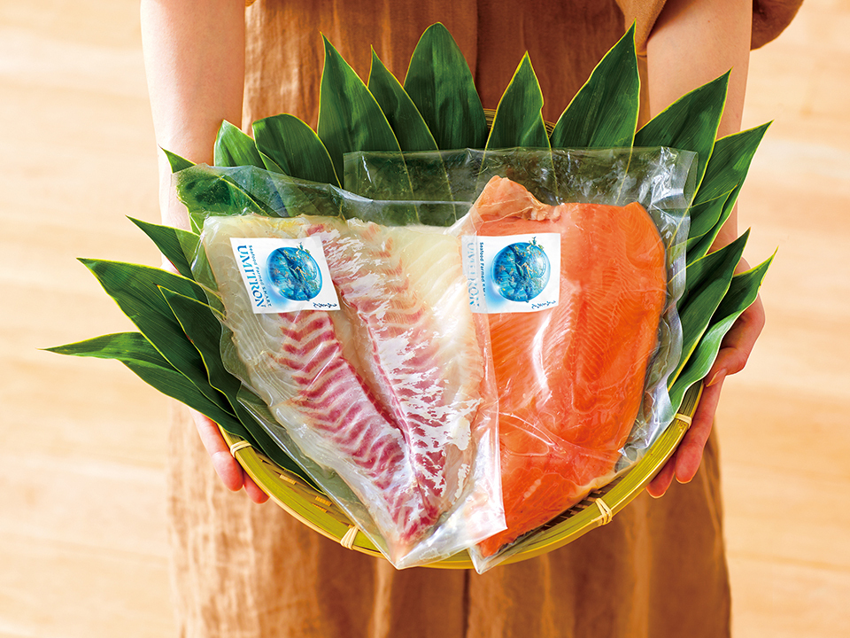 Packaged filets of fish on top of leaves in a woven basket