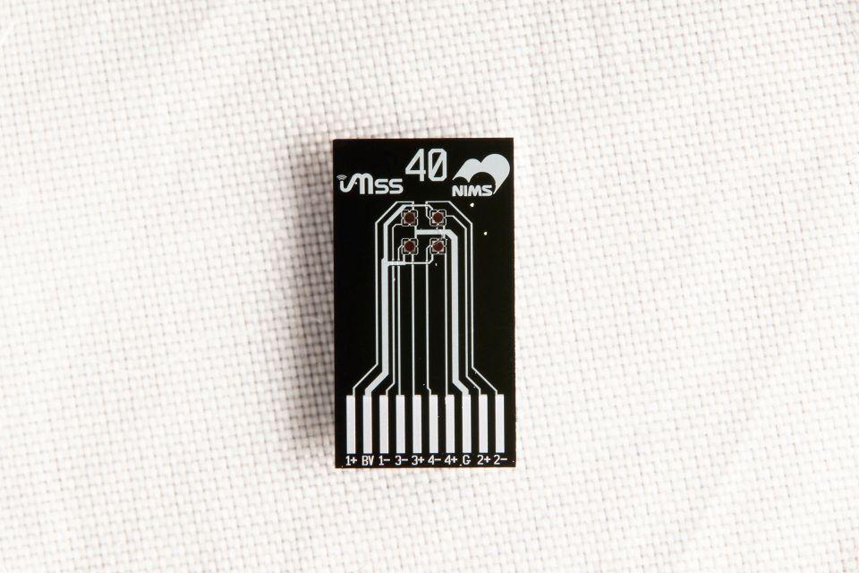 Photo of a small black chip that can be used to detect odors
